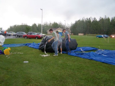 The Inflatable Gymnasium crew scramble to put it away as the rain starts
